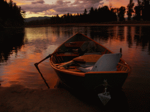 One of Stu Williams's custom-built boats on the river at sunset.