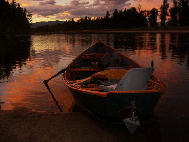 One of Stu Williams's custom-built boats on the river at sunset.