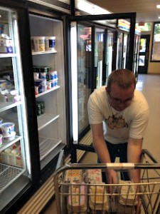 Ian stocks the coolers at the Missoula Food Bank.