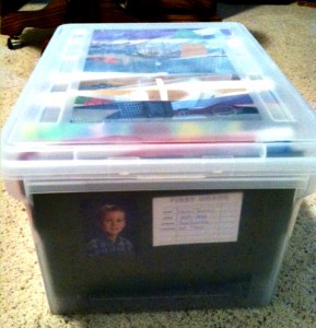 A full bin of Erin's son's organized art and school work.