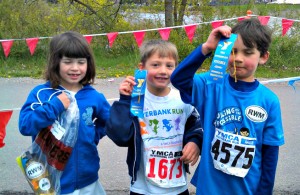 Eva's son, Milo, and two of his friends proudly show off their Missoula River Bank Run ribbons.