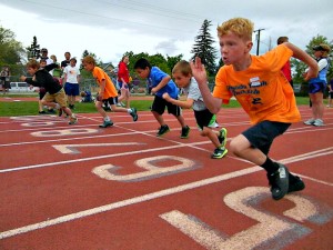 A group of boys run the 100m dash at the Missoula Youth Track Meet.
