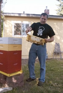 Christian Russell, a hobbyist beekeeper, holds a section of honeycomb from his hive.